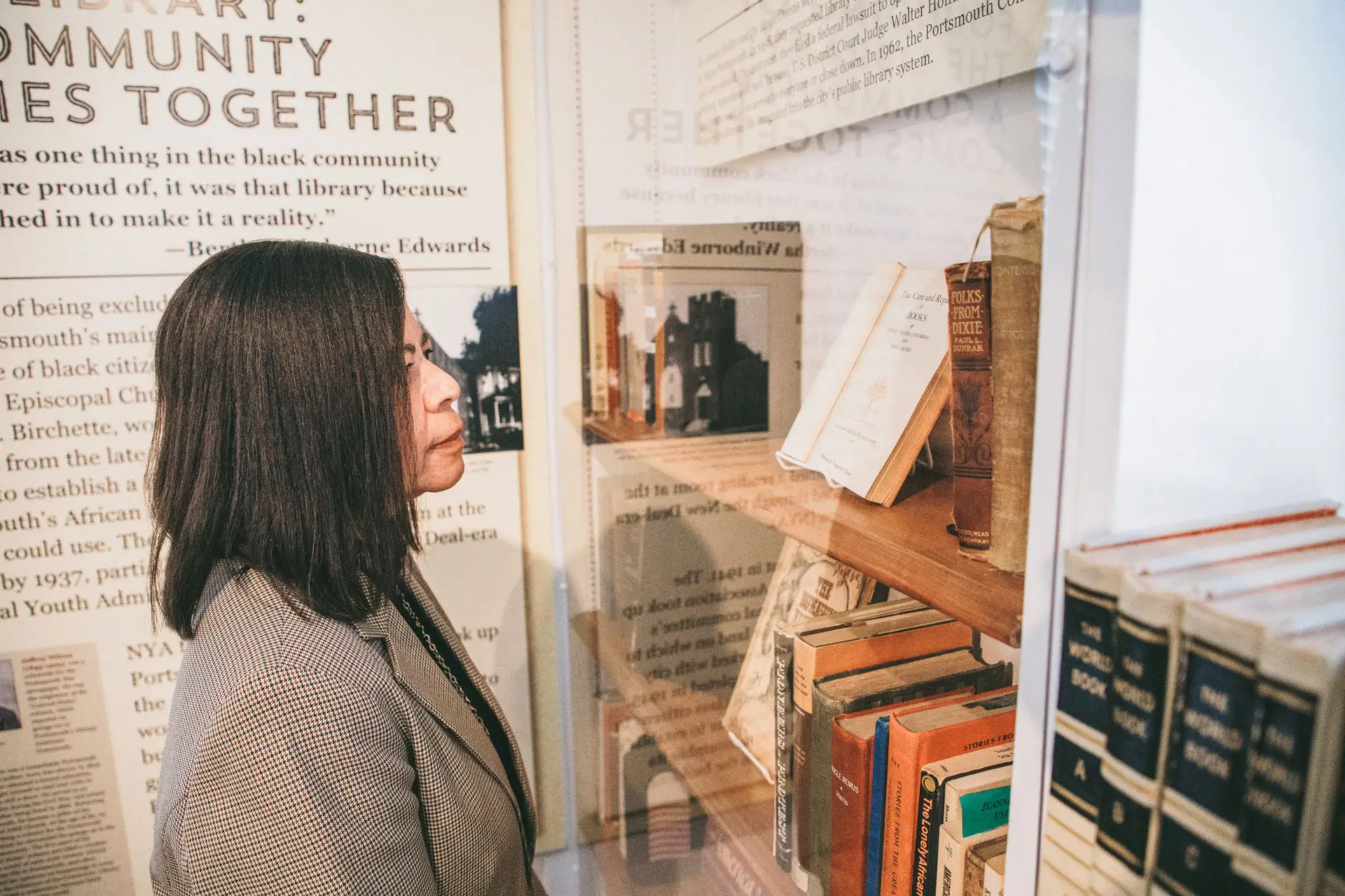 Woman viewing an exhibit at the Portsmouth Colored Community Library Museum